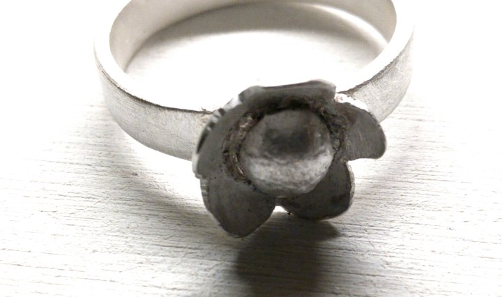 sterling silver ring with a flower at the top
